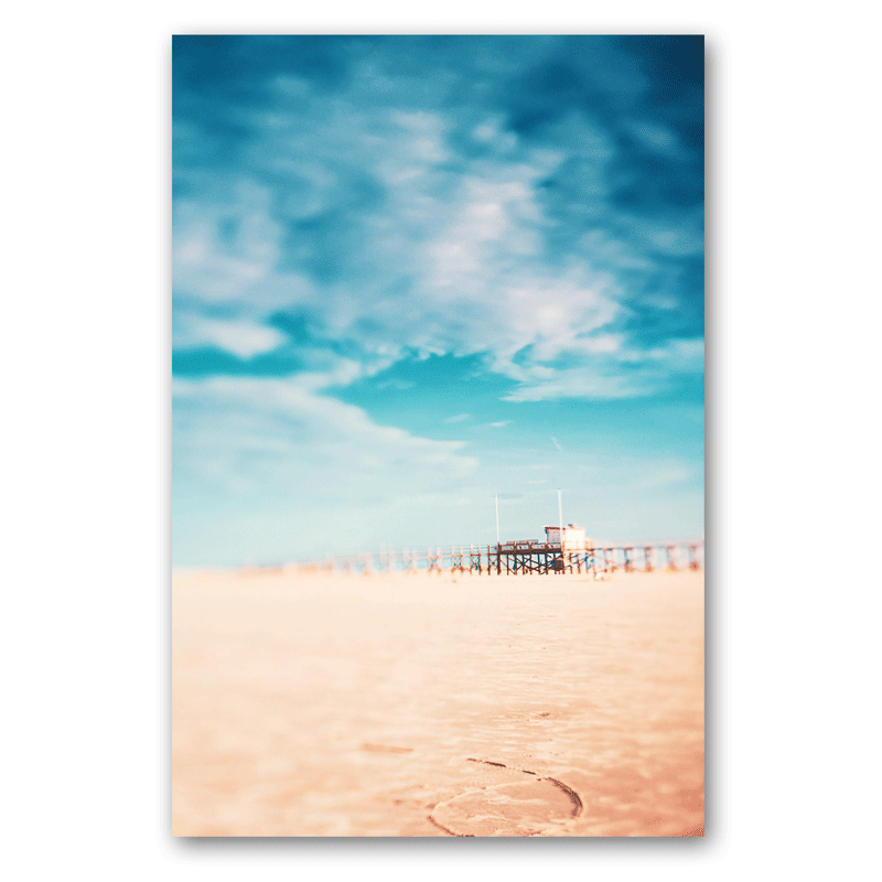 Ein Steghaus am Strand vor blauem Himmel